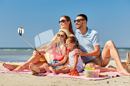 Image of happy family taking selfie on summer beach