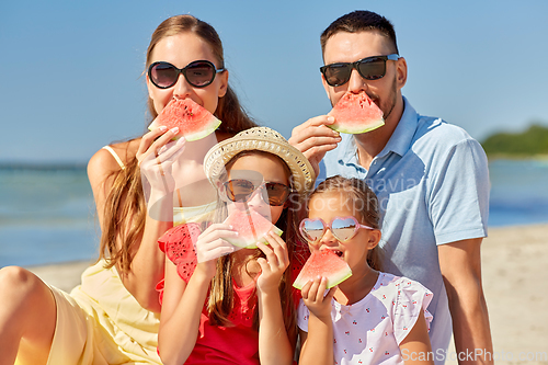 Image of happy family having picnic on summer beach