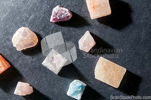 Image of quartz crystal pyramid and gem stones on slate