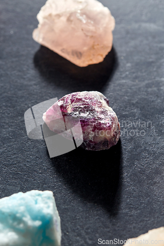 Image of quartz crystals and gem stones on slate background