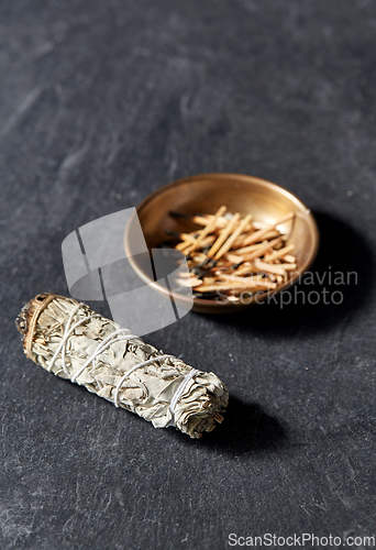 Image of white sage and cup with burnt matches