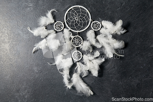 Image of dreamcatcher on dark slate stone background