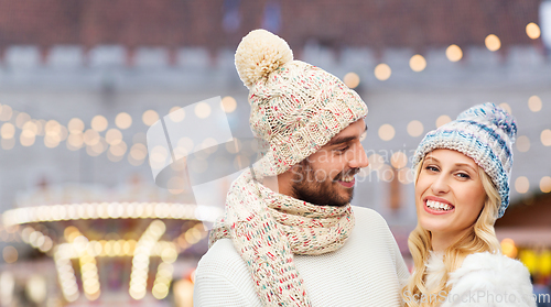 Image of couple in winter clothes at christmas market