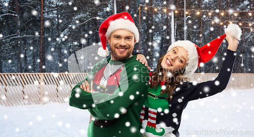 Image of happy couple in ugly sweaters on christmas