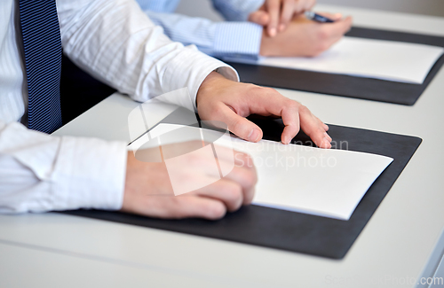 Image of close up of businessman with papers at office