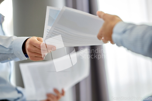 Image of close up of business team with papers at office
