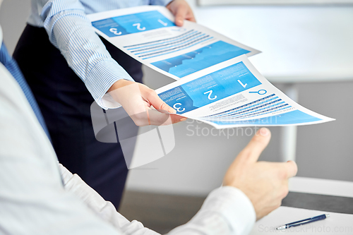 Image of close up of business team with papers at office