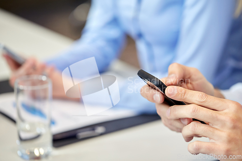 Image of hands with on smartphone at office