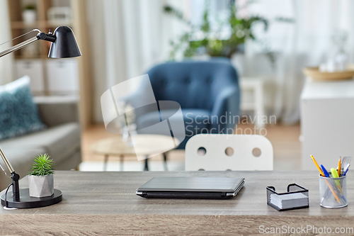 Image of laptop and stationary on table at home office