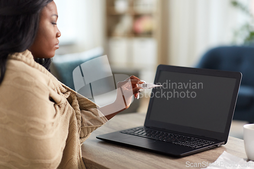 Image of sick woman having video call on laptop at home