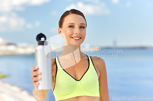 Image of woman drinking water from bottle after sports