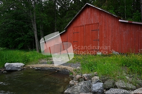 Image of traditional old red finnish boat shed by the lake