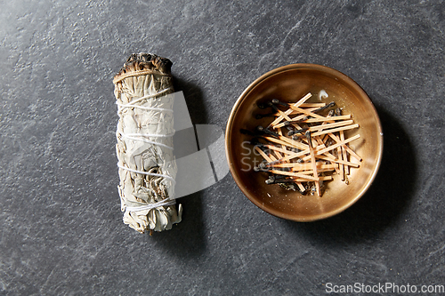 Image of white sage and cup with burnt matches
