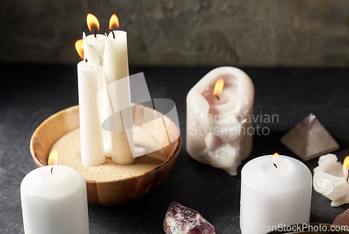 Image of burning candles and crystals for magic ritual