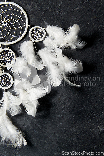 Image of dreamcatcher on dark slate stone background