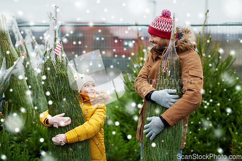 Image of happy family buying christmas tree at market