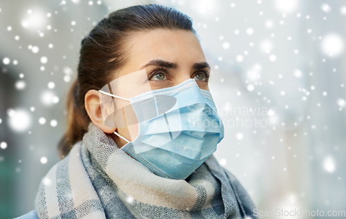 Image of young woman wearing protective medical mask