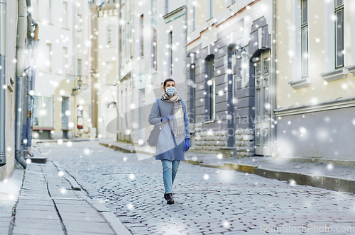 Image of young woman wearing protective medical mask