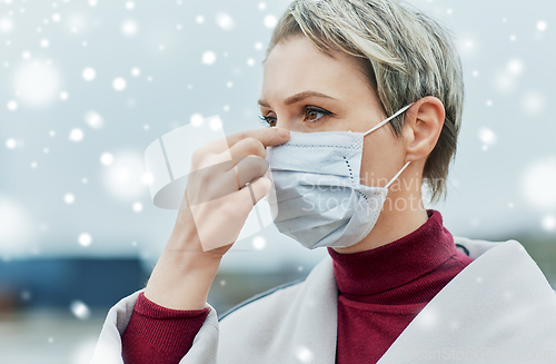 Image of young woman wearing protective medical mask