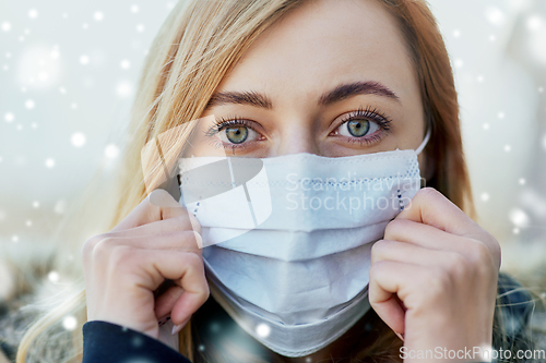 Image of young woman wearing protective medical mask