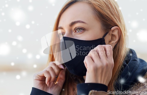 Image of woman wearing protective reusable barrier mask