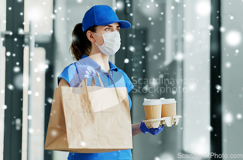 Image of delivery woman in face mask with food and drinks