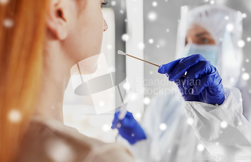 Image of doctor in protective wear making coronavirus test