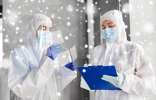 Image of doctors in medical mask and shield with clipboard