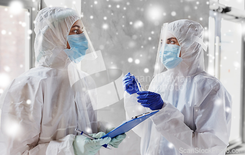 Image of doctors in medical mask and shield with clipboard