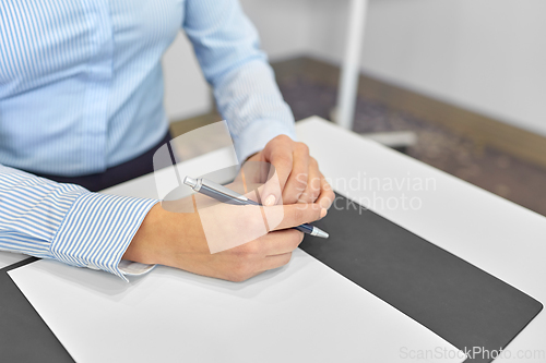 Image of close up of businesswoman with paper at office