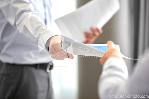Image of close up of business team with papers at office