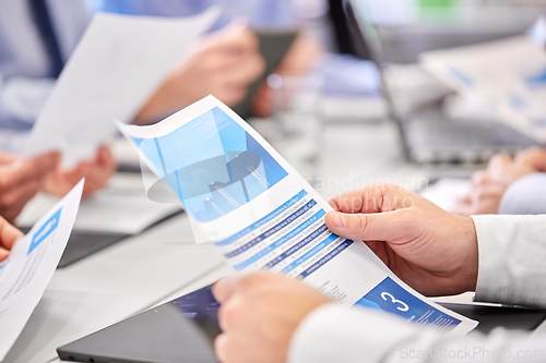 Image of close up of business team with papers at office