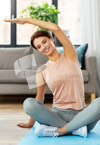 Image of happy woman exercising at home