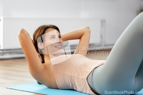 Image of woman exercising at home gym