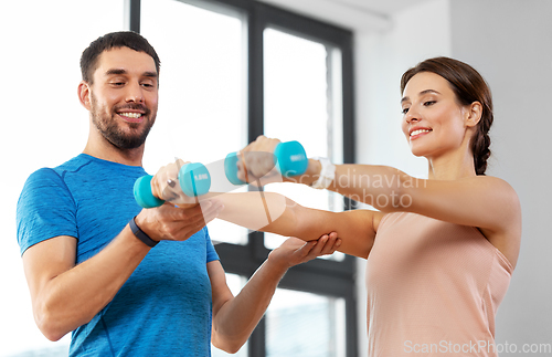 Image of happy couple exercising at home