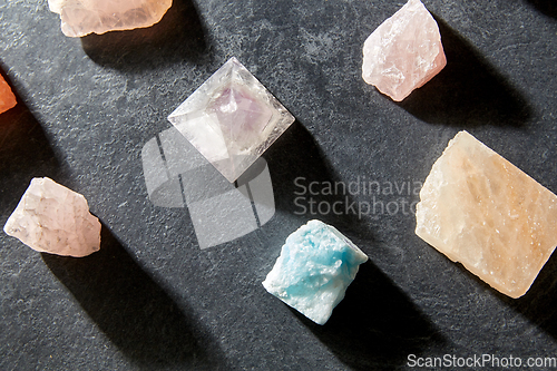 Image of quartz crystal pyramid and gem stones on slate