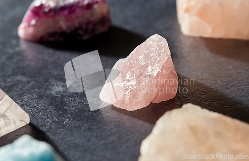 Image of quartz crystals and gem stones on slate background