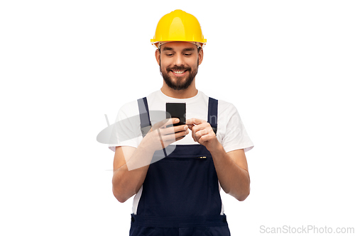 Image of happy male worker or builder with smartphone