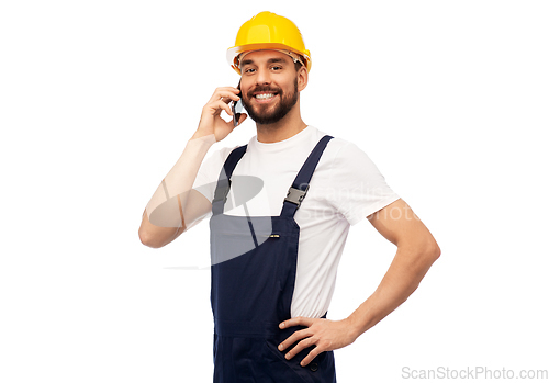 Image of happy male worker or builder calling on smartphone