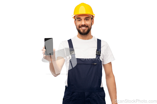 Image of happy male worker or builder showing smartphone