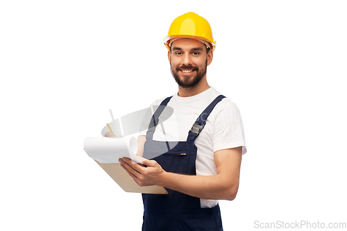 Image of male worker or builder in helmet with clipboard