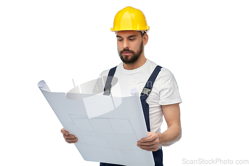 Image of male worker or builder in helmet with blueprint