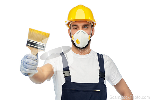 Image of worker or builder in respirator with brush