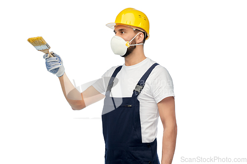 Image of worker or builder in respirator with brush