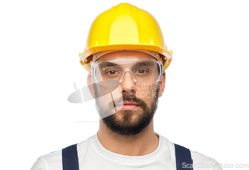 Image of male worker or builder in helmet and overall