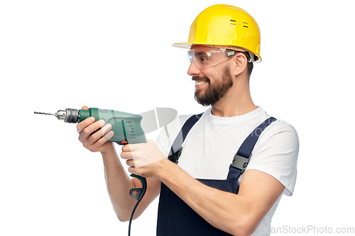 Image of happy male worker or builder in helmet with drill