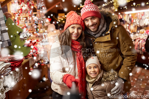 Image of happy family taking selfie at christmas market