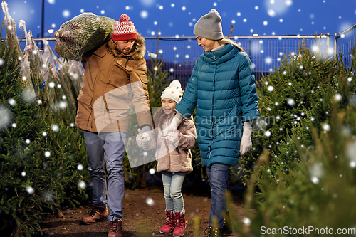 Image of happy family buying christmas tree at market