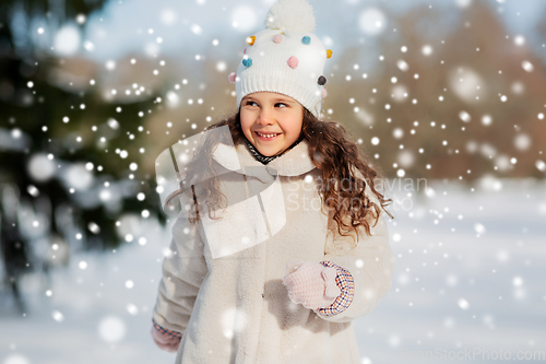 Image of happy little girl in winter clothes outdoors