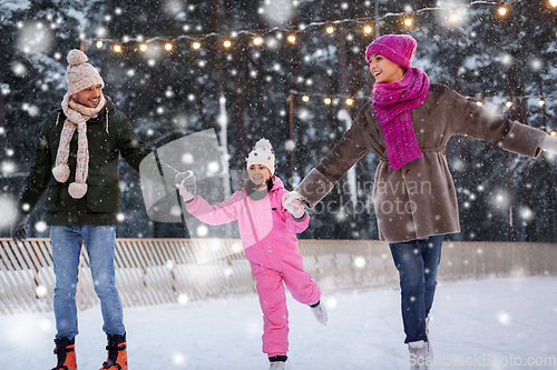 Image of happy family at outdoor skating rink in winter